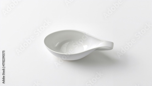 An empty sauce-boat on a plain background, suitable for culinary layout