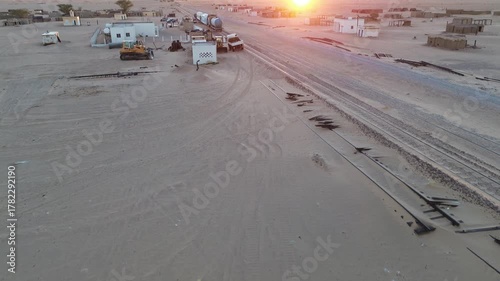 Freight train passing Ben Amera monolith at sunrise, Adrar, Mauritania