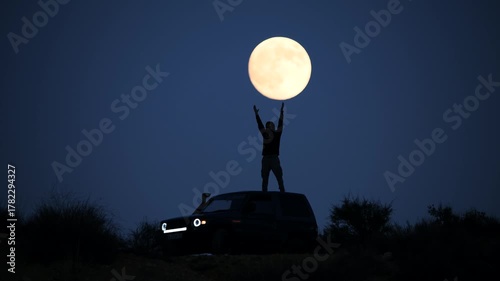Surreal Silhouette Holding the Moon in Front of 4x4 Vehicle