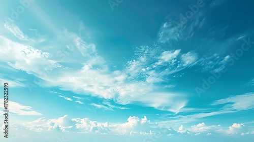 Fototapeta Naklejka Na Ścianę i Meble -  A view of a bright blue sky with fluffy white clouds scattered throughout the scene