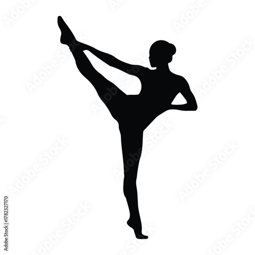 Silhouette of a ballerina performing a high leg extension
