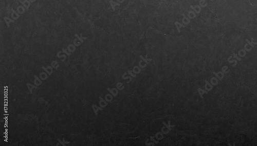 Black graphite texture on cardboard, rough surface suitable for editorial header background
