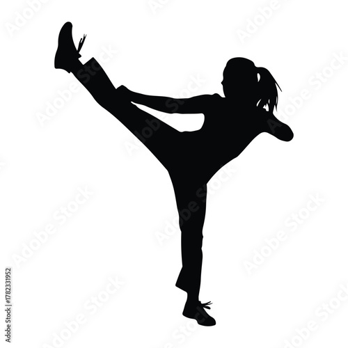 Silhouette of a girl performing a high kick woman martial arts