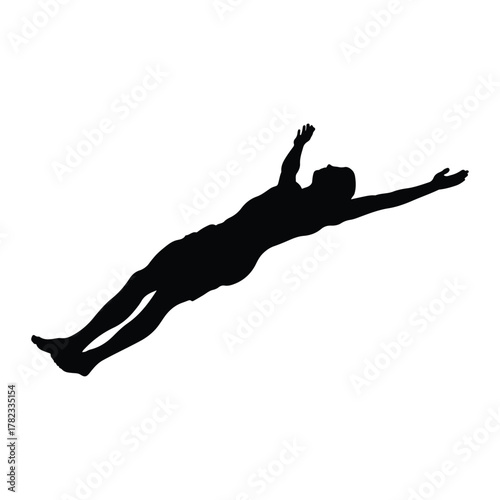 Silhouette of a man diving with arms outstretched swimming