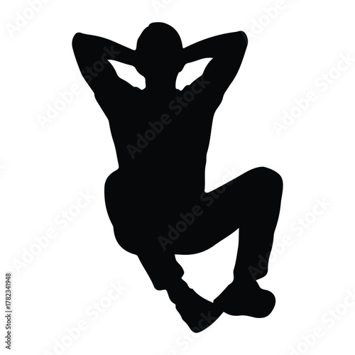 Silhouette of a man sitting with hands behind head