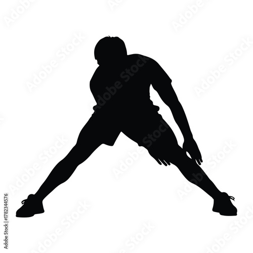 Silhouette of a man stretching his legs in a wide stance