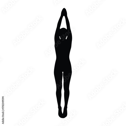 Silhouette of a person in a yoga pose with arms overhead
