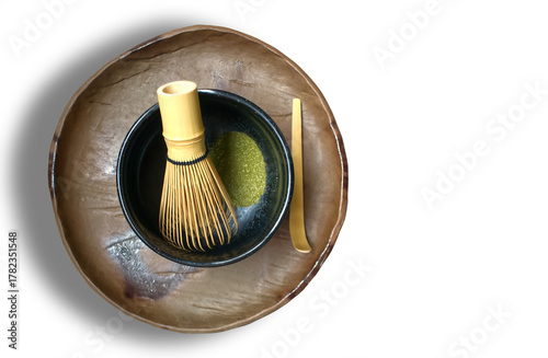 Green tea powder with a tea whisk in a bowl