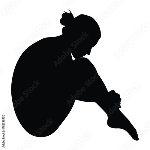 Silhouette of a woman curled up in a thoughtful pose