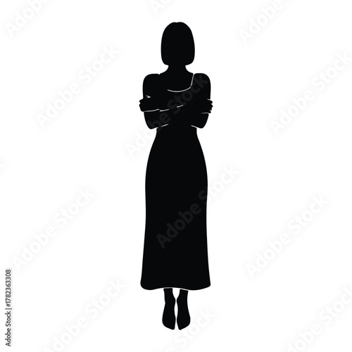 Silhouette of a woman in a long dress with arms crossed