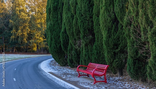 A red bench nestled among g...