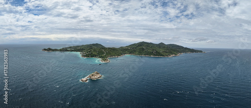 stormy rugged coast, misty island with turbulent seas, overcast isle showcasing rough waters Koh Tao Thailand