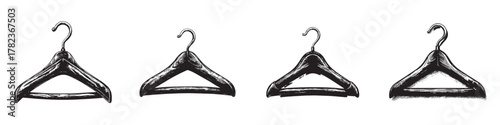 A collection of four vintage-style clothing hangers on a white backdrop.