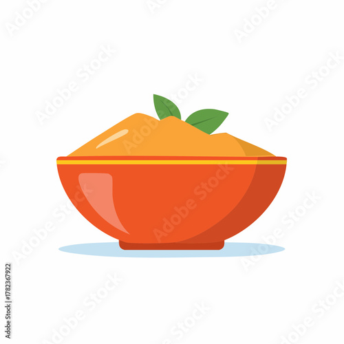 Vibrant orange bowl filled with smooth orange puree and garnished with green leaves