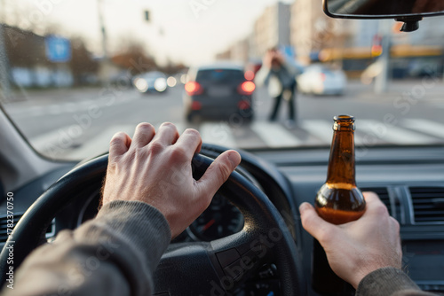 A driver driving with a bottle of beer in their hand poses a danger to pedestrians, other drivers, and themselves.  , social advertising about the dangers of drunk driving