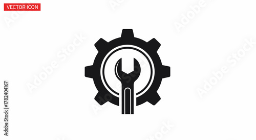 Black and white vector graphic featuring a wrench positioned vertically inside a gear.