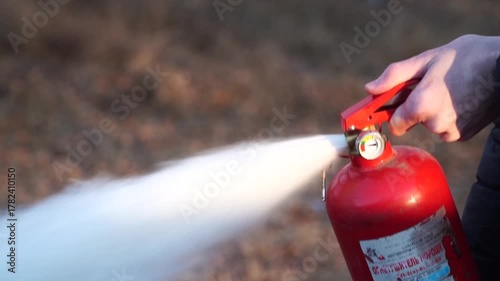 Man using fire extinguisher in a fire.