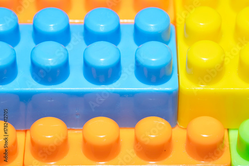 Plastic colored construction blocks, close-up.