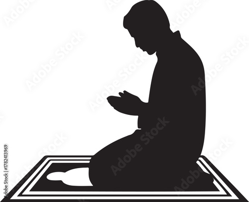 Silhouette of a man kneeling and praying on a prayer mat muslim
