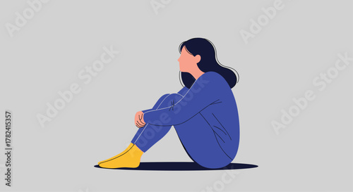 Pensive young woman sits alone, embracing her knees and gazing thoughtfully into the distance, conveying emotions of solitude, contemplation, and quiet reflection.