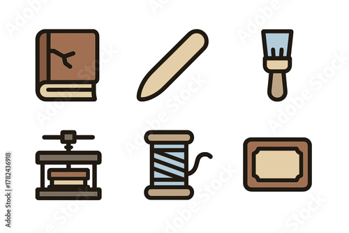 Tools of bookbinding and crafting displayed together in a creative workspace setting