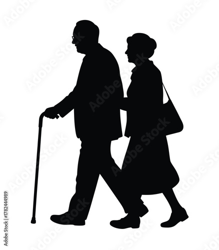Silhouette of an elderly couple walking together with a cane