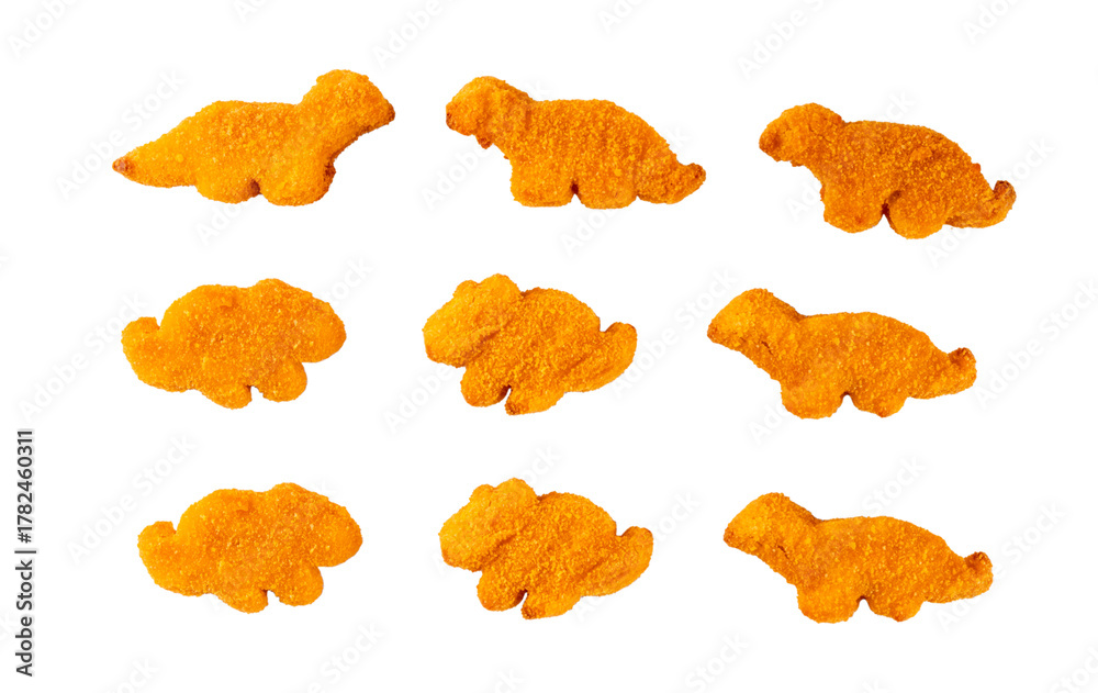 Fototapeta premium Tasty kids food, dinosaur shaped chicken nuggets. Plate with dino nuggets and sauce and vegetables, healthy and fun air fried dino nuggets