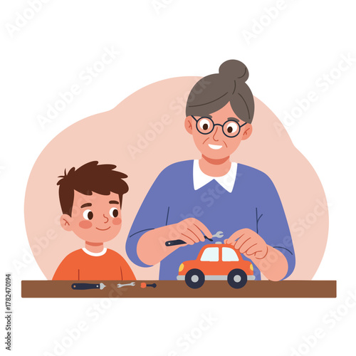 A smiling boy watches as a gray-haired woman repairs a toy car with tools. They are together at a table