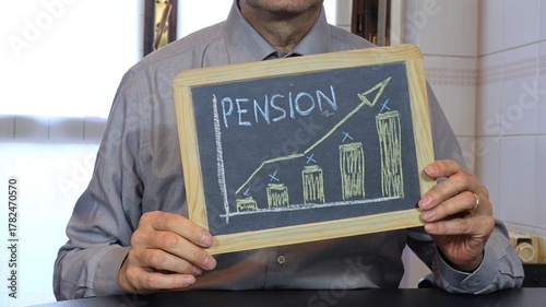 A chalkboard with the word pension written on it. A man holds a slate board.