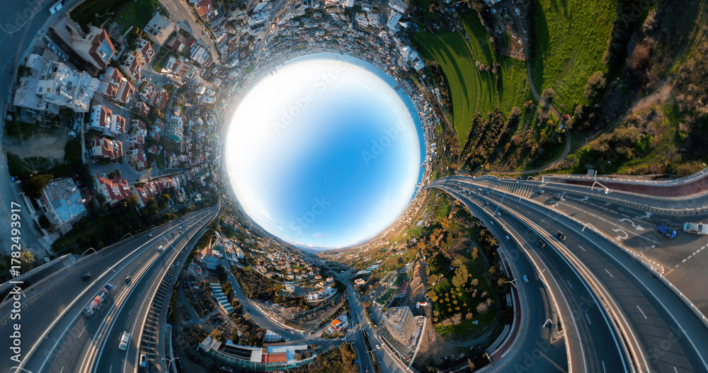 Fototapeta premium Limassol cityscape bending into spherical panorama, revealing urban landscape and highway network against vibrant blue sky from aerial perspective