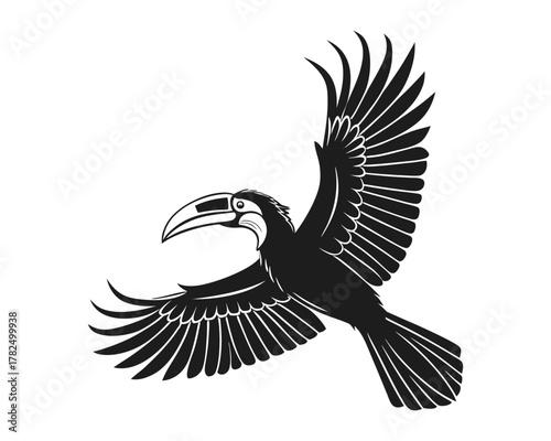 A black silhouette of a toucan with a skull-like head and large, detailed wings spread wide in mid-flight