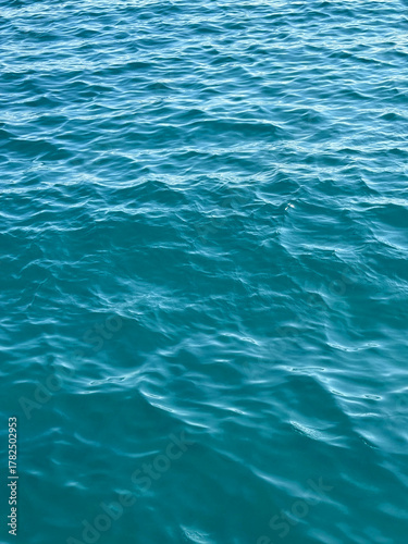 Blue ocean waves vertical background.