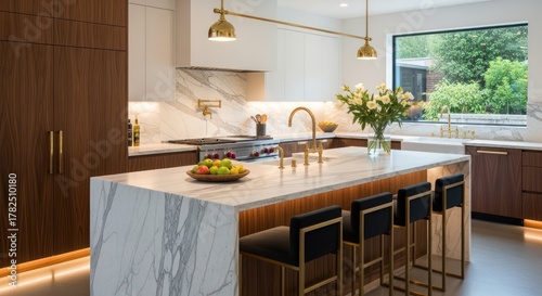 Modern luxury kitchen design featuring marble island, sleek walnut cabinetry, and elegant brass fixtures creating a sophisticated entertaining space.