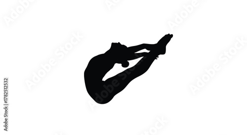Silhouette of a gymnast performing a backflip on a for artistic purposes