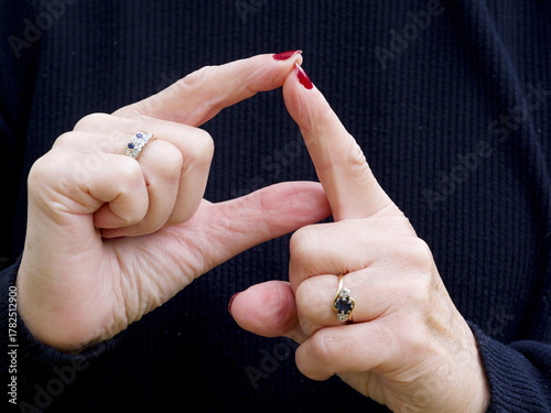 Obraz na plátně A pair of hands signing the consonant letter 'D' in British Sign Language