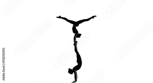 Silhouette of two acrobats performing a handstand, showcasing strength, balance, and teamwork