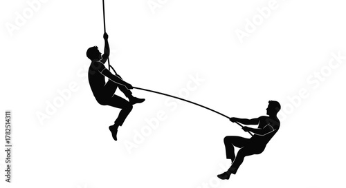 Silhouette of two men engaged in a tug of war competition