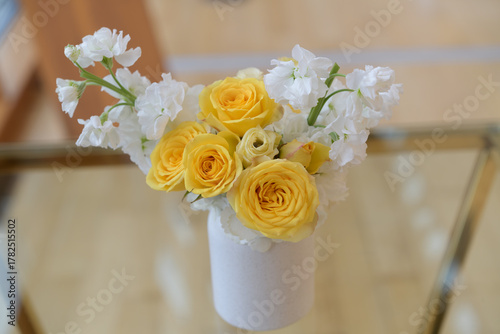 yellow roses and white Matthiola incana arrangement indoors