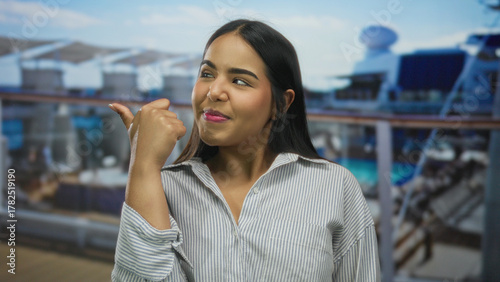 Wallpaper Mural Woman thumb pointing boat young latin hispanic outdoors deck smiling against blurred sea background. Torontodigital.ca