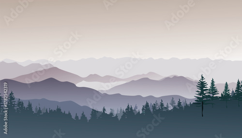 Beautiful mountain landscape with trees in foreground and a hazy sky above