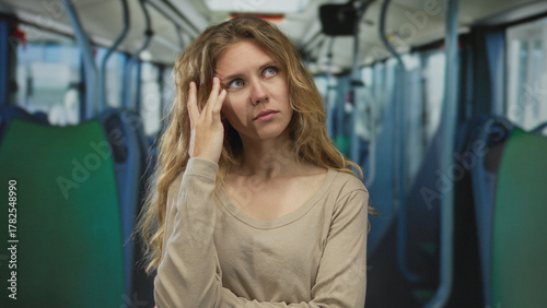 Free Download Woman hair touching bus blonde young pensive transport interior seat framed in a cinematic portrait. - GFXLoad