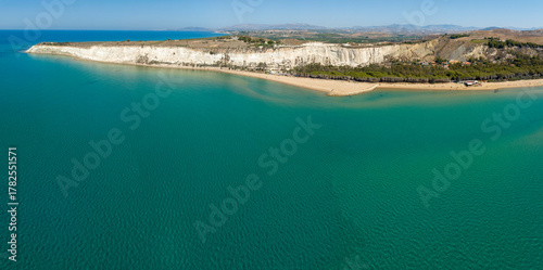 Fototapeta Naklejka Na Ścianę i Meble -  Panoramic aerial view of Eraclea Minoa beach, located in province of Agrigento, Sicily, Italy. It's characterized by a high white cliff. It's a beautiful sunny day. The Mediterranean sea in foreground
