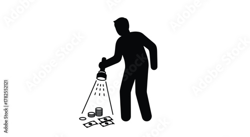 Silhouette of a person using a flashlight to illuminate money on ground