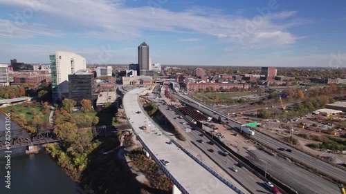 Aerial view and drone shot above new American highway, multi-lane roadway, and car traffic on road under construction and being built above old infrastructure in Columbus, Ohio downtown city area