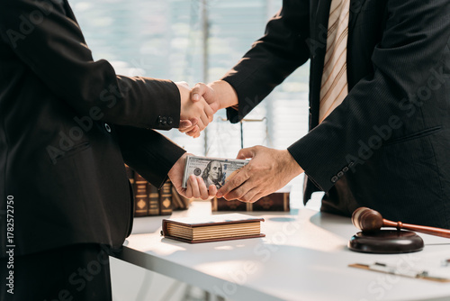 Deal Handshake & Bribery : A decisive handshake seals an under-the-table financial transaction. Two figures exchange a bundle of money, with the gavel in the corner hinting at the law.
