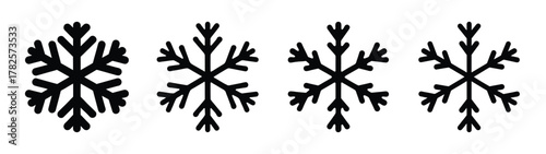 Collection of four distinct black snowflakes featuring intricate crystal formations and unique arm structures