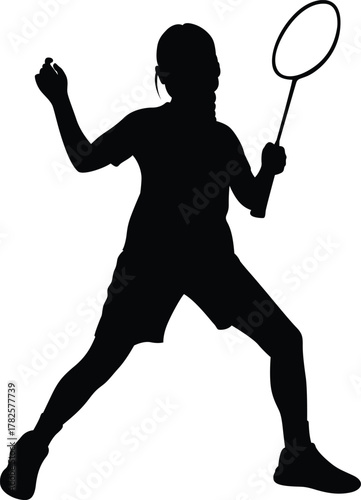 Silhouette of a young woman playing badminton with a racket and shuttlecock in a dynamic pose