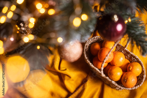 tangerines and fir branches on a dark background as a background for Christmas