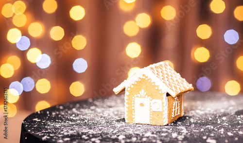 gingerbread man in a cup of cocoa with marshmallows on a Christmas background among New Year lights