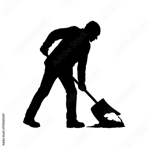 Hardworking silhouette of manual laborer shoveling dirt and debris on a construction site